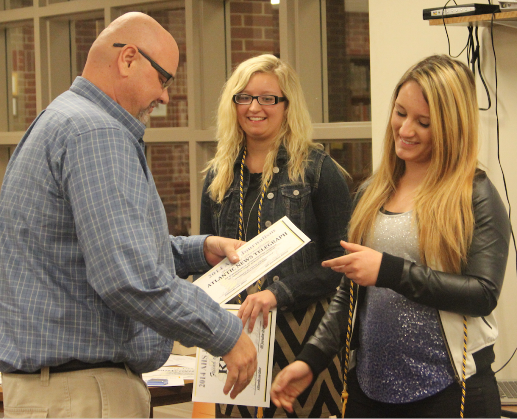 New Quill & Scroll members Sierra Smith and Meghan Plambeck thank Jeff Lundquist, publisher of the Atlantic News Telegraph for his support of student journalism. AHS students have the opportunity to write for Lundquist's publication.