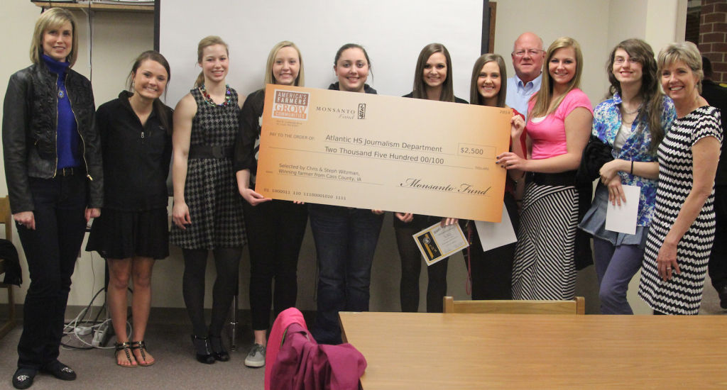 Steph Witzman, winner of Monsanto's Grow Communities fund presents a check for $2500 to AHS journalists. Monsanto representative Ted Wallace was on hand for the presentation.