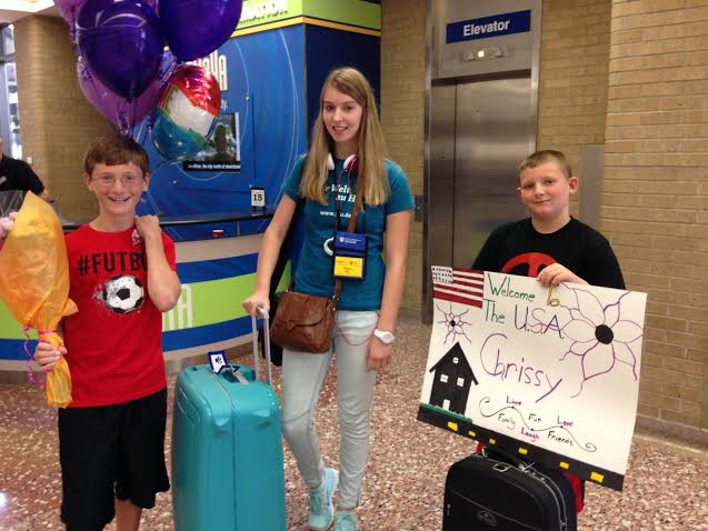 Zachary and Devin McKay welcome new sister Chrissy Hitz at Eppley Airport in Omaha on Friday. Hitz will live with the McKay family and attend AHS this coming school year. - Photo contributed by Heather McKay