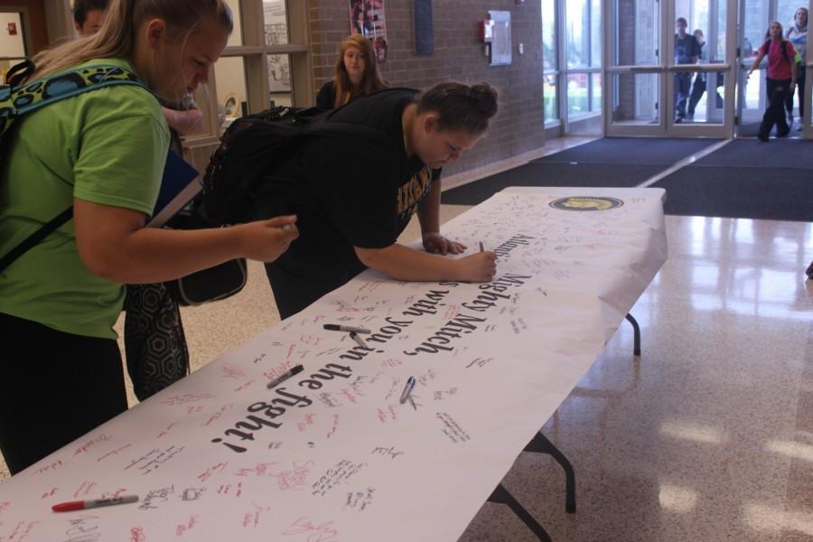 Senior Paige Anstey posts a note on the Mighty Mitch sign.  All students and faculty were encouraged to share a thought on the sign.  This will be shared with Osborn.  