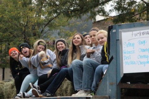 Atlantic's volleyball team perches on hay bales. Each fall sport was represented in the parade.