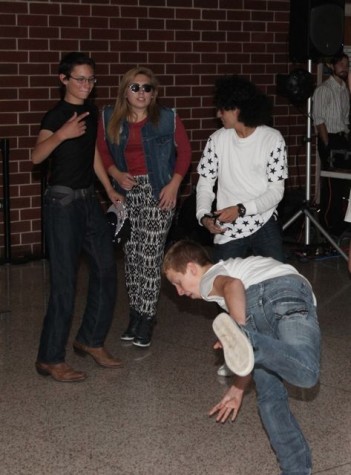 Sophomore Ethan Stoural starts break dancing in the middle of sophomore Sydney Redler and Garrett Grooms. 