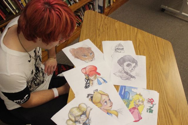 Sophomore Hunter Oliver displays some of his art. The Sugar Skull on the top-right is a design Oliver drew for his mothers tattoo.
