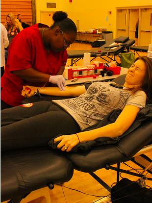 
Junior Kaylee Roach cringes as the needle is put
 into her arm. Roach is a returning blood donor, and plans on donating again next year.