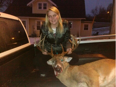Junior Madisen Sandhorst stands with her buck after an early morning of hunting. 