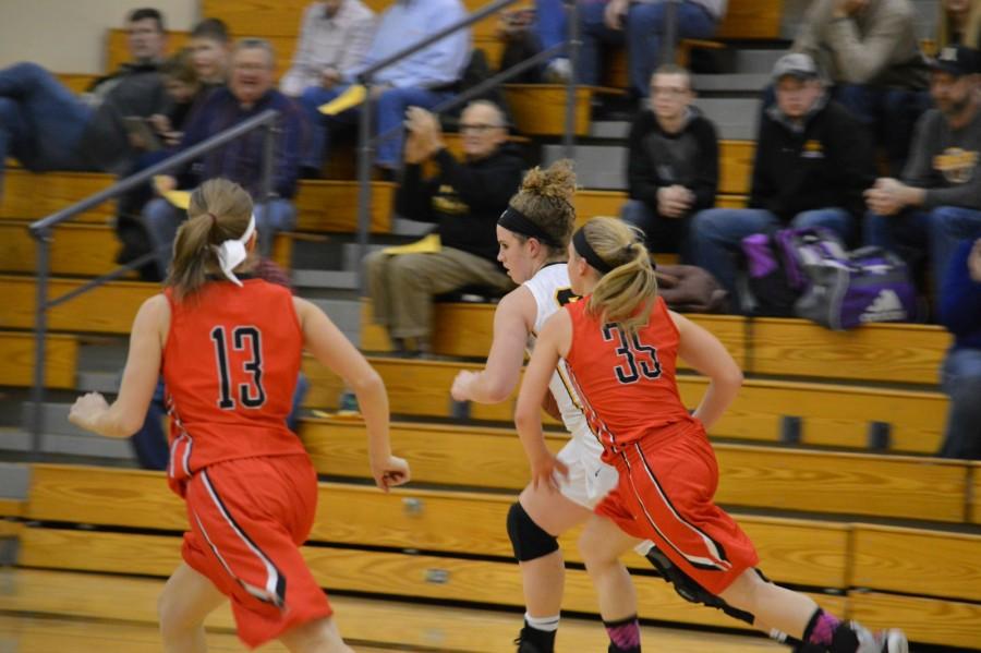 Sophomore Catherine Leonard races the ball down the court in hopes of scoring a basket.  The Atlantic Trojans lost against the Harlan Cyclones, 67-24.