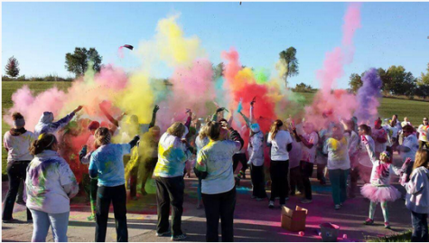 Participants fling colors into the air at the Color Blast After Party.