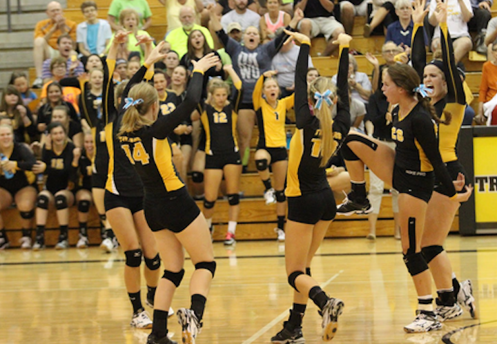 Trojans celebrate after successfully blocking a spike. The Trojans lost all three games to the Rams. 