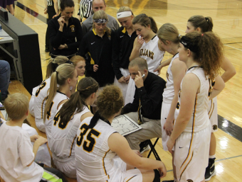 The girls basketball team meets with their coach before the game last night against the Denison Monarchs. 