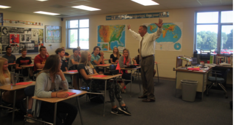 History teacher Terry Hinzmann expresses his feelings about semester tests nonverbally.