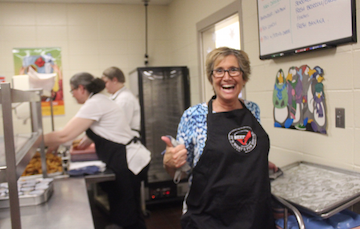 SMILE FOR BEEF - Food service director DeeAnn Schreiner excites the students for beef.