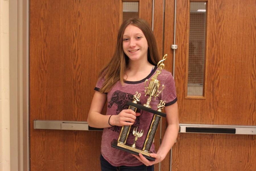 Freshman, member of the Diversity choir, Emma Joyce shows off the 4th place trophy.