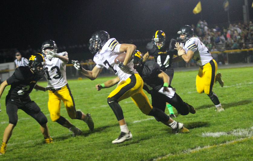 Wide reciever Garrett Franken runs the ball at the Winterset game Friday night. Franken has played football two out of his four years in high school.