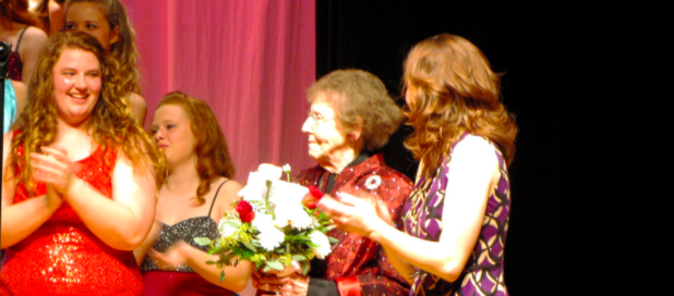 AWARD WINNING ACCOMPANIST-choir accompanist Ardie Dusenberry receives flowers for her birthday during the 2014 Swing Inn concert. Dusenberry received an honorary letter in 2016 for her contribution to the choir department. She accompanied the choir from 2012 to 2015.