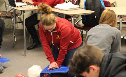 Sophomore Katie York gives the manikin CPR.       
York participated in the class, but she is already certified in CPR as a lifeguard.