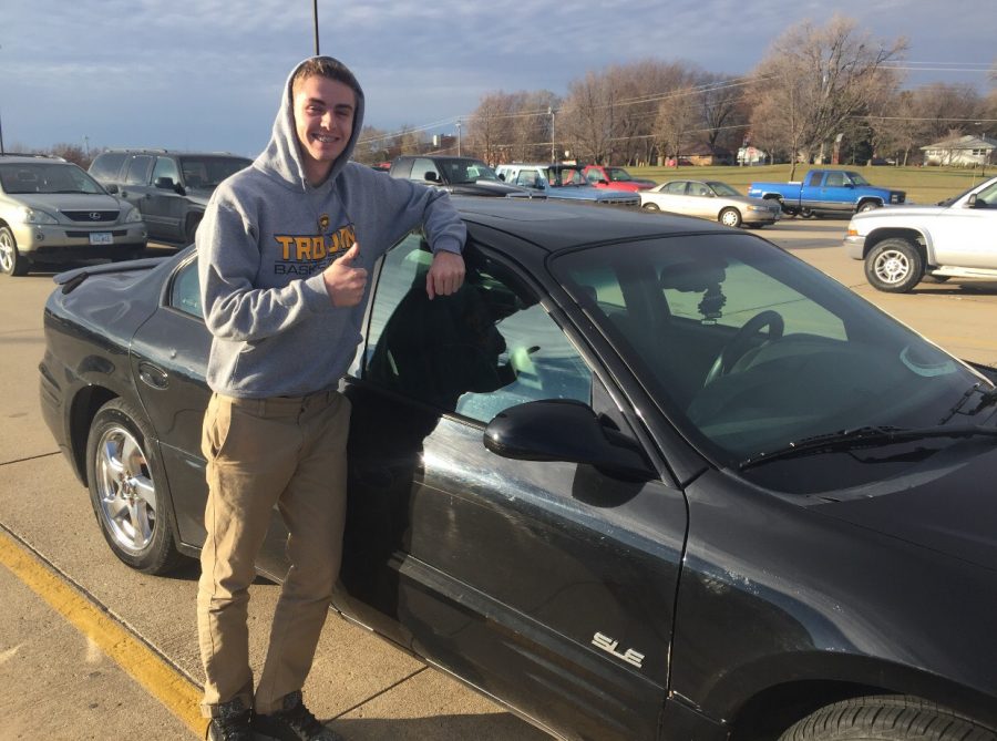 Junior Dillon Sonntag poses next to his Pontiac Grand Prix. Sonntag bought the car at the beginning of his junior year. He loved the car as soon as he laid his eyes on it. 