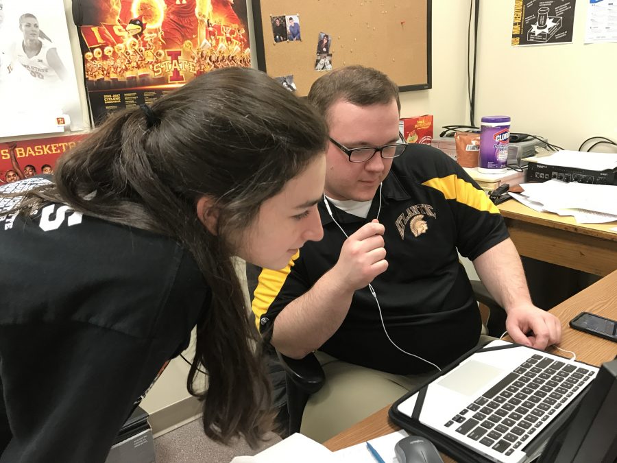 WORKING HARD: Junior Riley Seufert and speech coach Alex Bales work on her broadcasting project that will be sent to judges for District Large Group