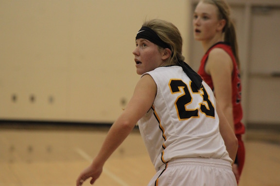 ALL EYES ON THE BALL - Sophomore Baylee Newell watches her team mate score the ball. Newell has been playing basketball since the fourth grade.