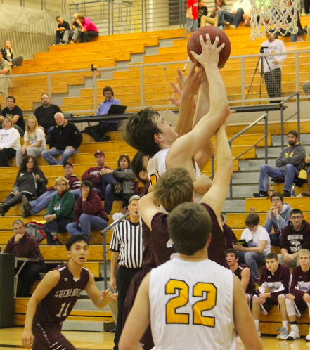 Senior Garrett Franken goes up for a rebound over Mustang defenders.