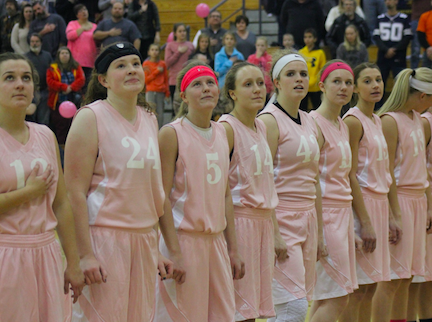 The girls stare at the flag before their pink out game vs. Denison. 