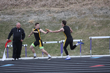 GIVE A BROTHER A HAND - Sophomore Sam Granner hands off the baton to senior Cody Buchman. 