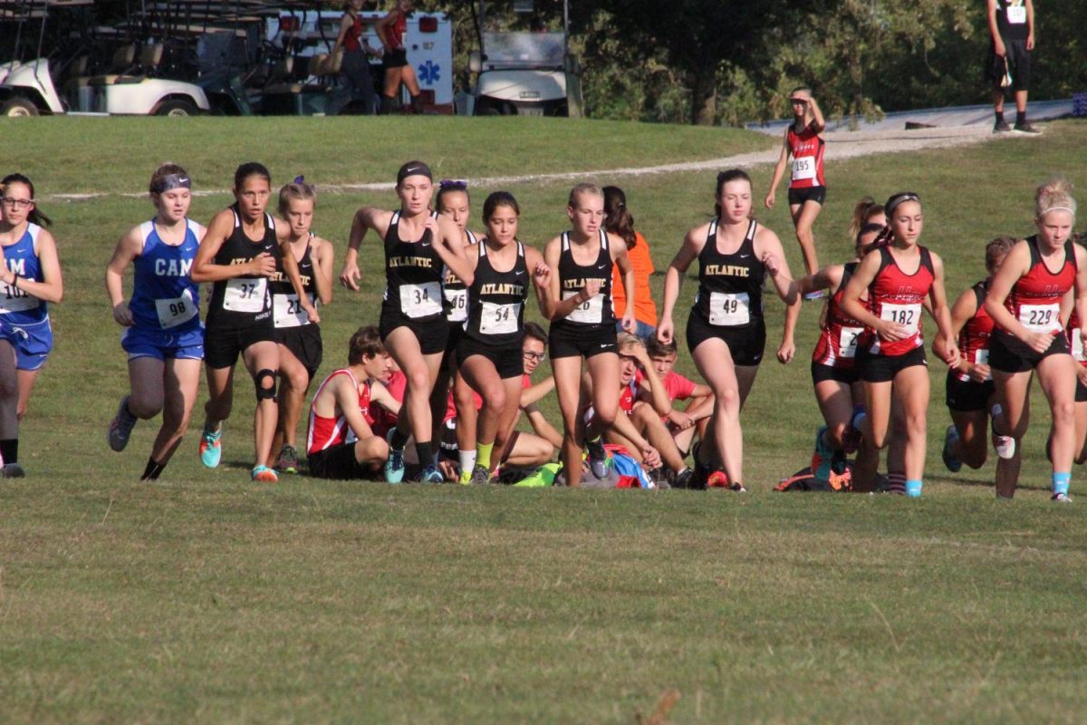 AND+THEYRE+OFF-+The+girls+varsity+team+takes+off+to+begin+their+race.++The+girls+finished+second+on+Saturday+in+Harlan.+