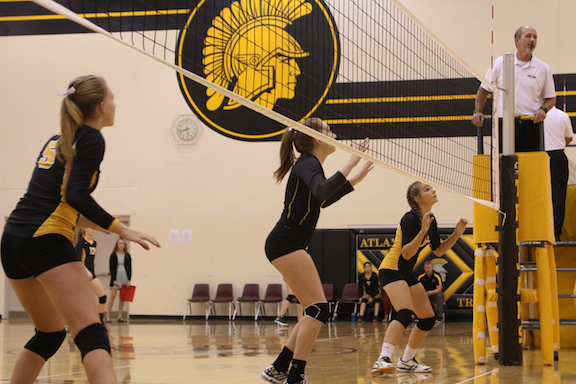 The volleyball girls prepare to block the return of an opponent last season. 