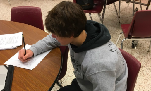 STUDY UP- Freshman Joe Weaver works in study hall. Students use these times to study and get other homework done for their classes. 