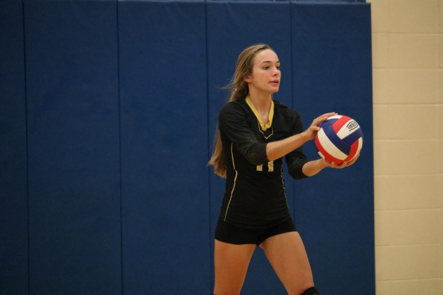 Sophomore Caroline Pellett gets ready to serve the volleyball at a meet earlier this season. Pellett subbed in to serve for JV this past Thursday. Through five matches, she didn’t miss a serve.