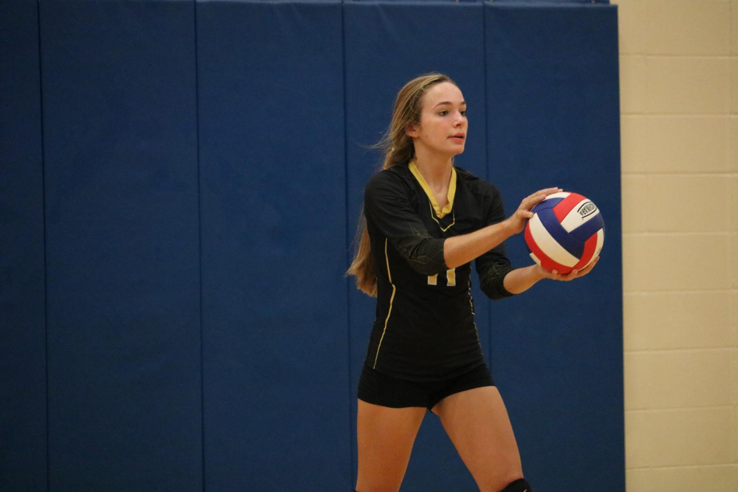 Sophomore Caroline Pellett gets ready to serve the volleyball at a meet earlier this season. Pellett subbed in to serve for JV this past Thursday. Through five matches, she didn’t miss a serve.