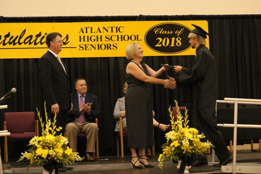 CONGRATULATIONS+-+2018+graduate+Brady+Dickerson+shakes+hands+with+Board+of+Education+member+Allison+Bruckner.+Graduates+received+their+diplomas+at+commencement+last+May.+