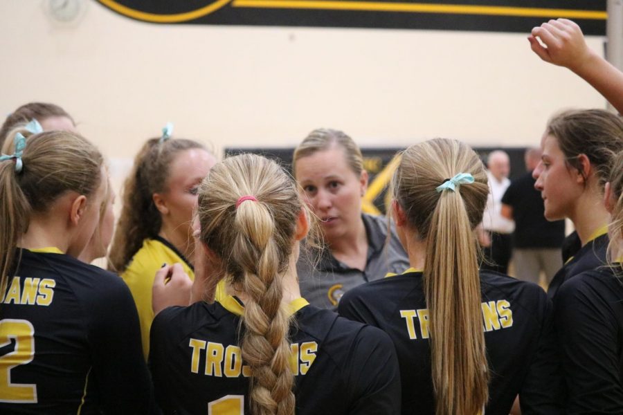 The volleyball girls listen intently to Coach Blakes instructions before heading out onto the court. 