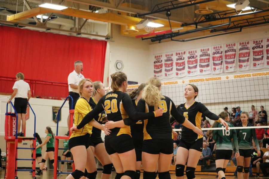 The JV girls huddle up at the tournament held at Kuemper Catholic earlier this season. 