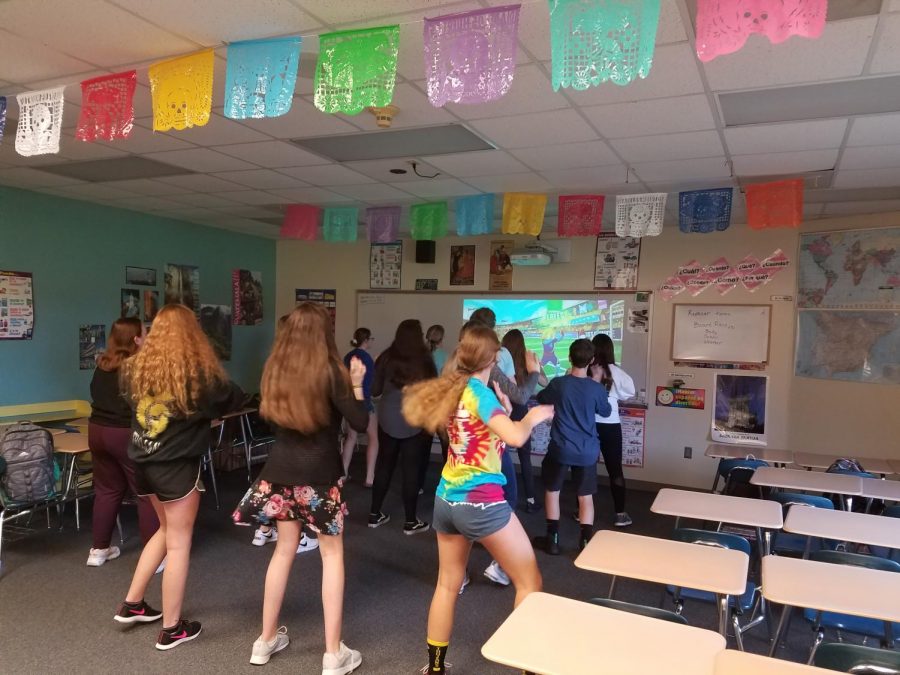 FOLLOW ALONG - Students dance with instruction during Bailes Viernes. This AO activity is held every Friday with Spanish teacher Trisha Niceswanger.