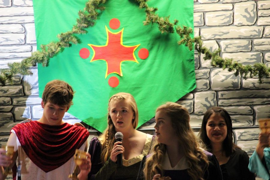 Last years seniors stand at the head table during the 2017 Madrigal Dinner. 