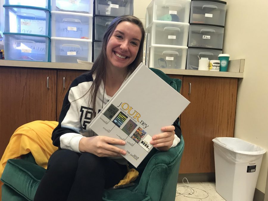 Senior Taylor Hansen holds the award-winning 2017-18 yearbook. Hansen designed the football, Homecoming, and girls’ basketball spreads.