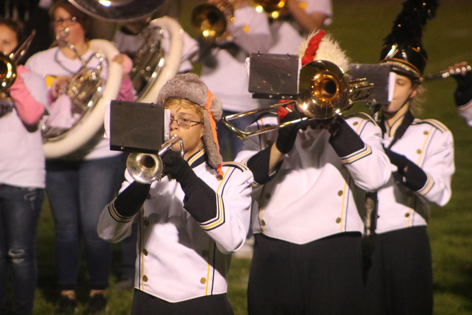 HOLD ON TO YOUR HAT - Senior Caleb Spurr plays during the last band performance. Spurr was a four-year band member, wearing a funky hat to symbolize that he is a senior.