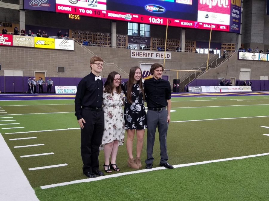 OH SAY CAN YOU SEE - Performing AHS choir members pose for a picture on the field of the UNI Dome. The quartet consisted of Chris Krogh, Ana Muell, Katie Saluk and Bradley Dennis.