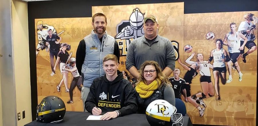 ITS OFFICIAL - Zade Niklasen smiles as he makes his commitment to Dordt College. Niklasen has been a four year letter winner for the Trojan football team and also participated in basketball and track during his years at AHS.