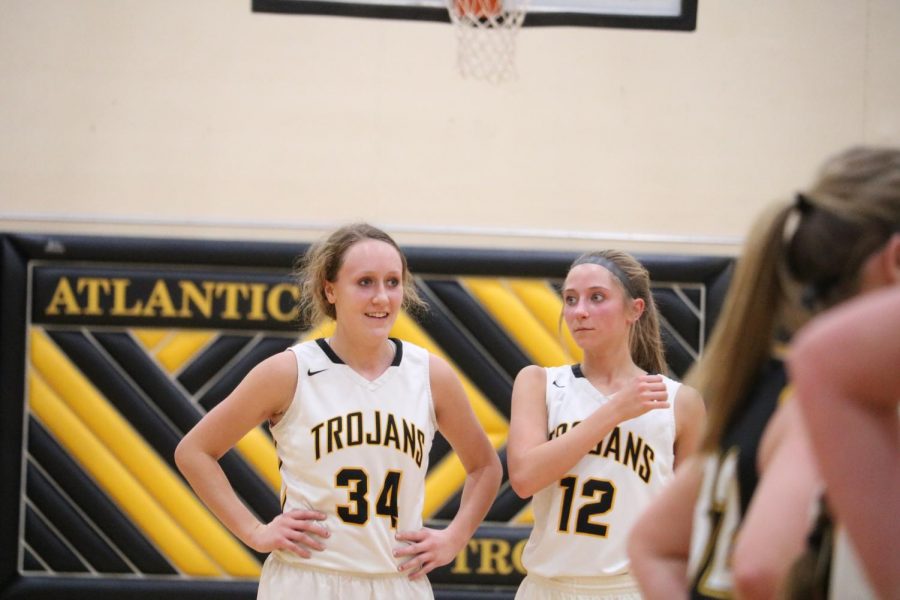 Junior Kenzie Waters and sophomore Haley Rasmussen chat at a free moment earlier in the season. In the last two games, both girls were the leading scorers for their team. Rasmussen has 83 points on the season, while Waters is close behind with 78. 