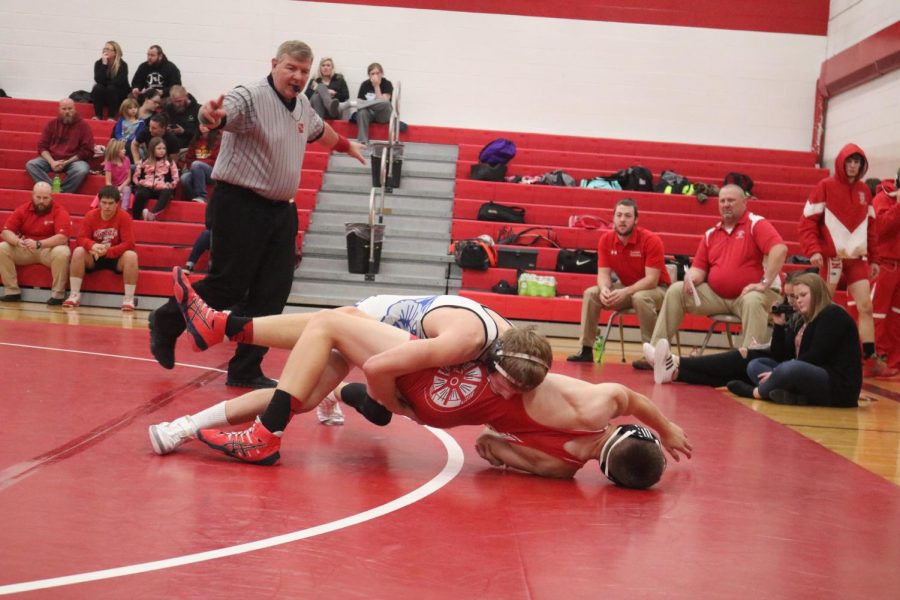 WATCH THE LINE - Senior Chase McLaren edges his way off the mat with an opponent. McLaren ended the night with one pin.