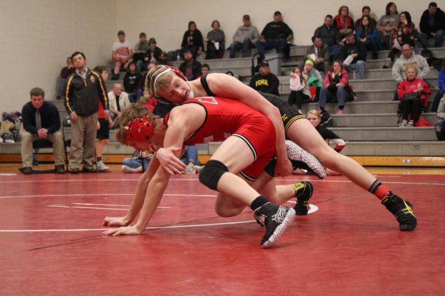 TAKING CONTROL - Freshman Kadin Stutzman attempts to topple his opponent from Creston. Stutzman won this match with a score of 16-6 in a major decision.
