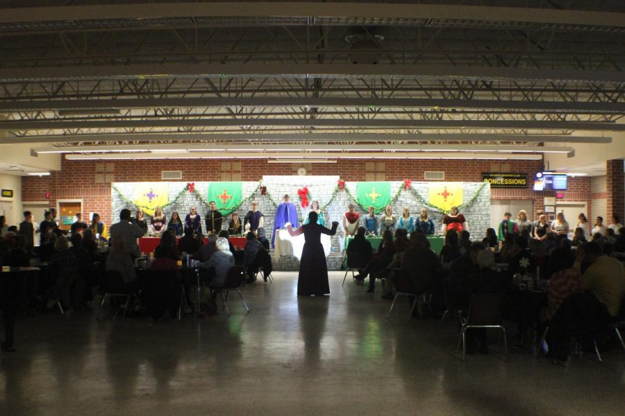 Director Jennifer Gasser conducts the senior song. Madrigal Dinner was attended by approximately 200 patrons.