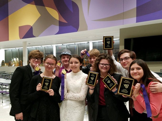 SHOWBOATING -- AHS participants at the Johnston Invitational hold up their plaques from a successful weekend. Seven top five finishes were earned throughout the tournament.