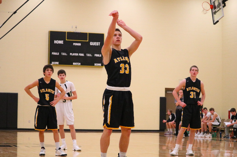 FOCUS IS KEY - Senior Zade Niklasen concentrates as he makes his free throw shot. Niklasen has recently committed to play football at Dordt College.