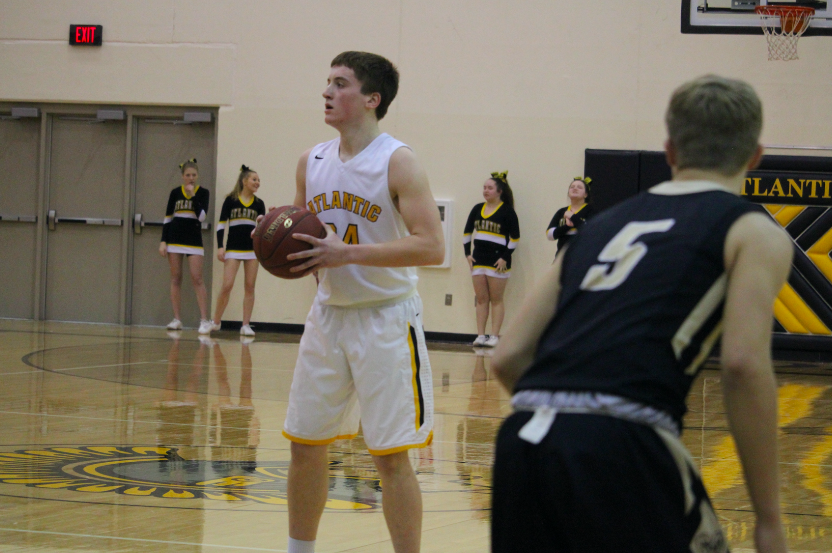 DECISIONS, DECISIONS - Senior Logan Reilly keeps a tight grip on the ball before choosing who to pass to. Reilly has been a consistent player for the varsity team. 