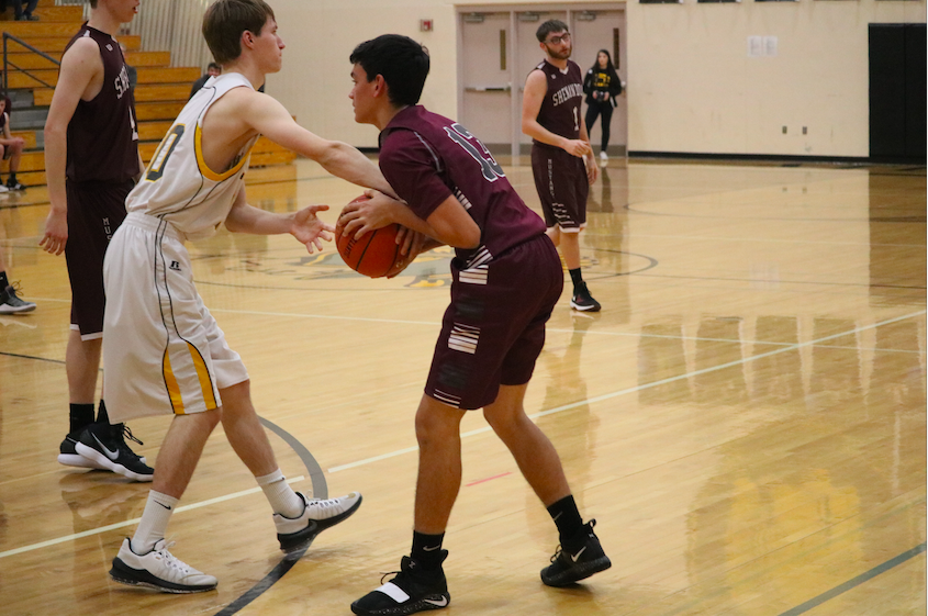 STRONG DEFENSE- Senior Cooper Leonard attempts to seal the ball during the JV game against the Senandoah Mustangs. Leonard has been a part of the basketball program for four years. 