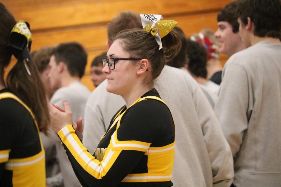 DOING WHAT I LOVE - Senior Chamilla Colton cheers during a wrestling meet. After being badly burned at just three years old, Colton was left with scars on her arms, chest and part of her face. She said she has used the experience to shape her into who she is today.