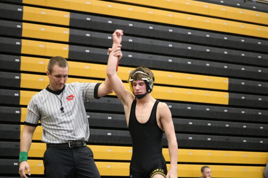 HARD+WORK+-+Sophomore+Joe+Weaver+has+his+arm+raised+by+the+referee+at+the+Red+Owens+Holiday+Classic+indicating+he+won+his+match.+Weaver+won+his+match+at+the+Harlan+duals+in+a+major+decision+and+did+not+wrestle+against+Denison+due+to+an+open+weight+class.+