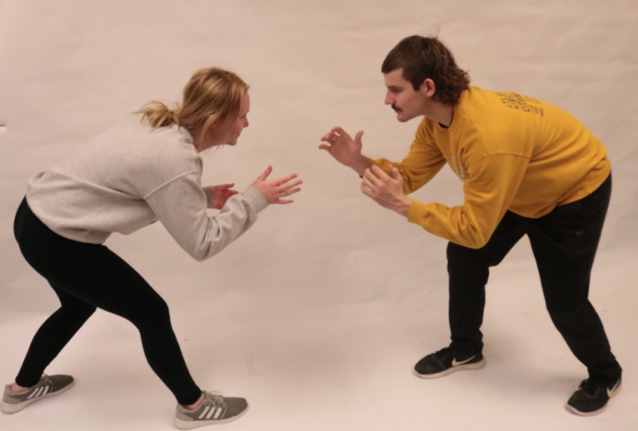 TAKE YOUR STANCE - AHS writer Mia Trotter learns the wrestling stance from senior wrestler Kenny Jimerson. 